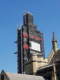 Low angle view of buildings against clear blue sky