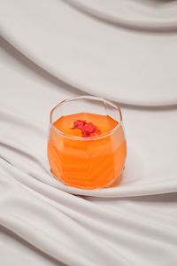 High angle view of orange drink on white background 