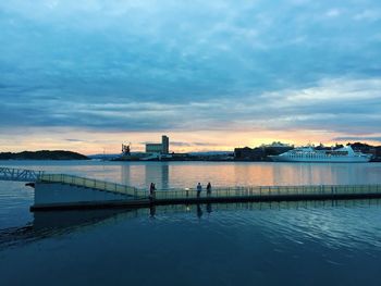 Scenic view of river against cloudy sky