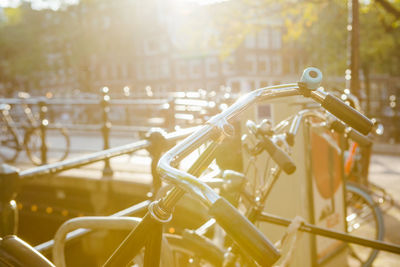 Close-up of bicycle parked by railing in city