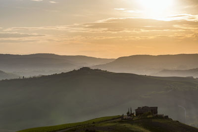 Predawn fog in the rolling landscape with houses on hills