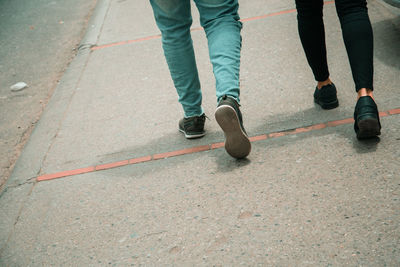 Low section of people walking on road