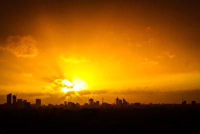 Silhouette of city during sunset