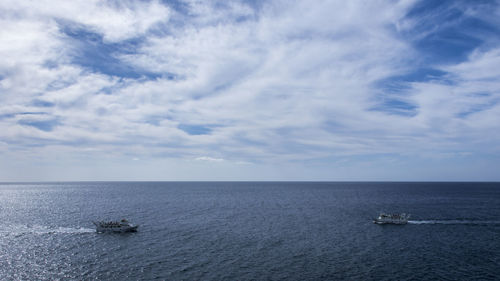 Ships sailing on sea against sky