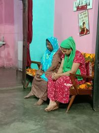 Full length of woman sitting in traditional clothing