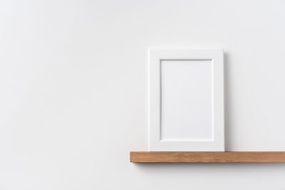 Close-up of empty chair against white background