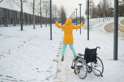 Happy caucasian woman got up from the wheelchair and jumping. happy girl recovers and starts walking