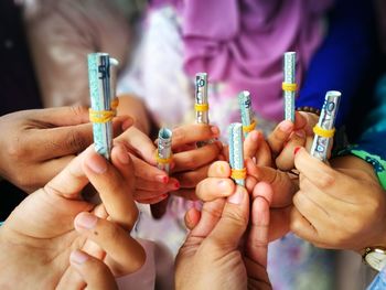 Close-up of people holding hands