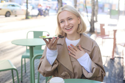 Portrait of young woman using mobile phone