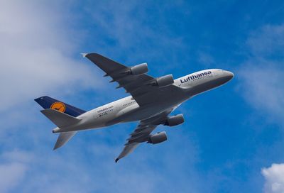 Low angle view of airplane flying in sky