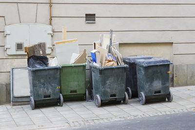 Stack of garbage bin against building