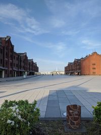 Buildings in town against cloudy sky