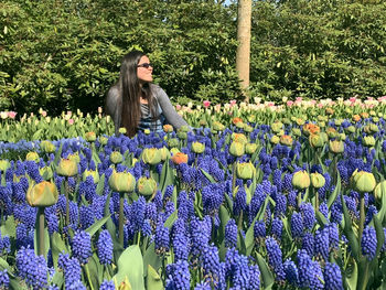 Woman lying relaxed by purple flowering plants