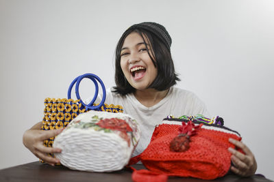 Young woman smiling against white background