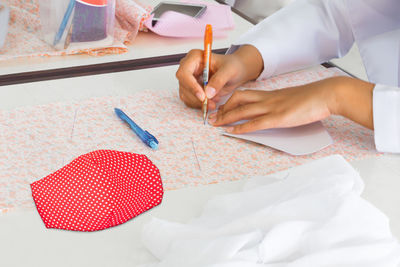 High angle view of woman hand on table