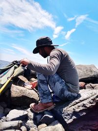 Side view of man on rock