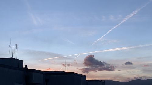 Low angle view of silhouette buildings against sky