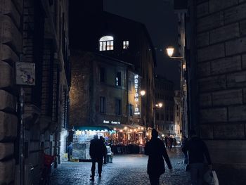 People walking in the ancient streets of rome in the eve