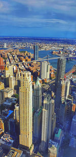 High angle view of buildings by sea against sky