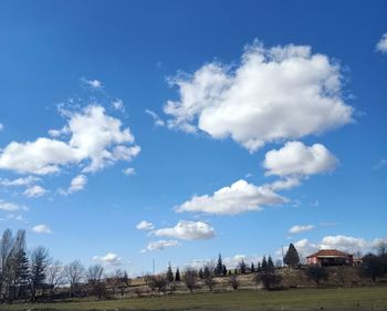 Scenic view of field against blue sky