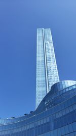 Low angle view of modern building against clear blue sky