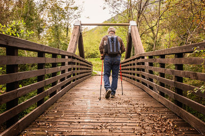 Full length of man standing on footbridge