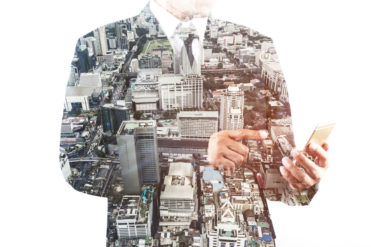 DIGITAL COMPOSITE IMAGE OF MAN AND BUILDING AGAINST MODERN CITYSCAPE