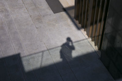 Shadow of person walking on street