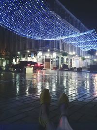 Woman in illuminated city at night