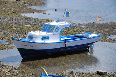 Boats moored on sea shore