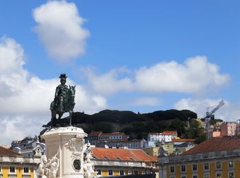 Low angle view of statue of king jose i at praca do comercio against sky
