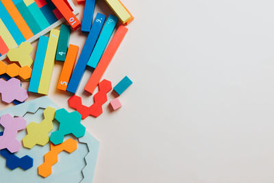 High angle view of multi colored toys on white table