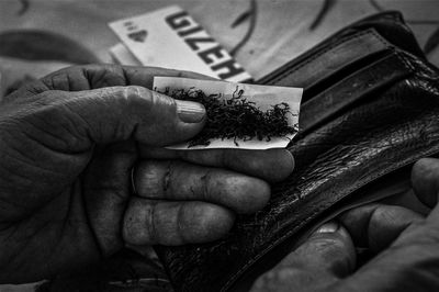 Close-up of hand holding cigarette