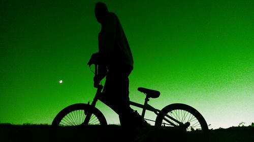 Side view of man riding bicycle