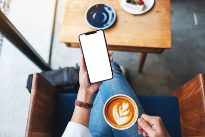 Low section of woman using mobile phone