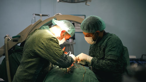 Doctors performing an appendectomy surgery, surgical concept