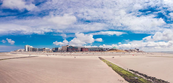 Panoramic view of beach and buildings against sky
