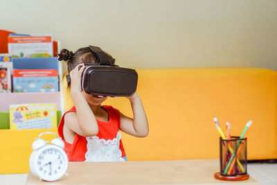 Close-up of cute girl wearing virtual reality simulator