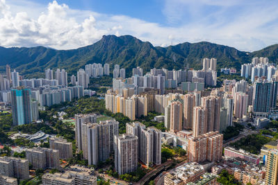 Panoramic view of buildings in city against cloudy sky