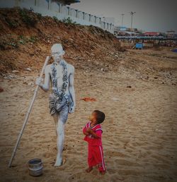 Full length of boy standing on shore