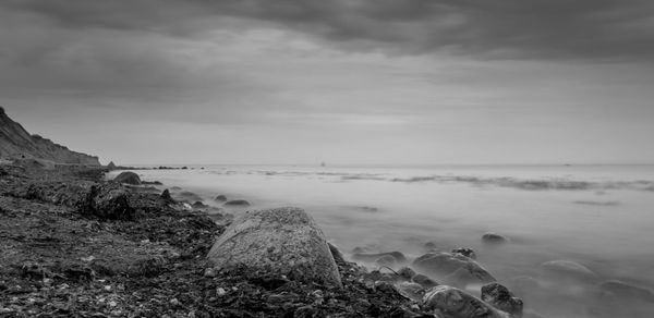 Surface level of calm beach against the sky