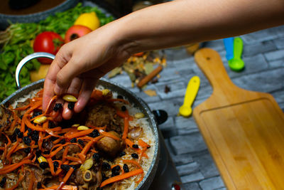 Cropped hand of man preparing food