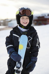 Smiling boy with skis