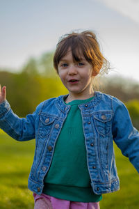 Portrait of cute girl standing on field