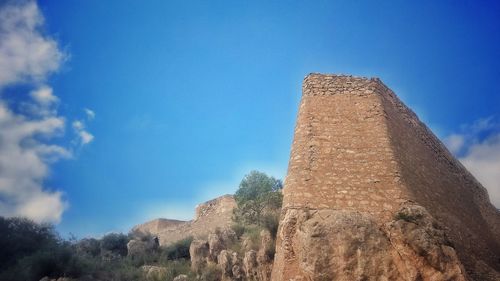 Low angle view of historical building against blue sky