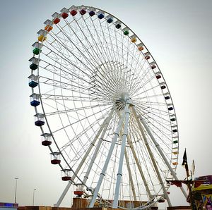 Low angle view of ferris wheel against clear sky