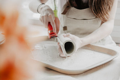 Midsection of woman at pottery workshop