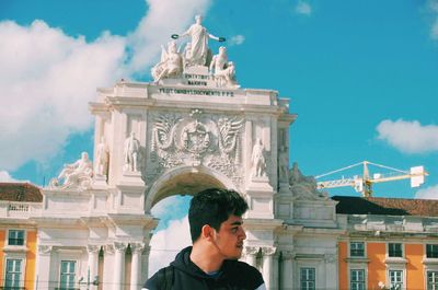 Man looking away while standing against rua augusta arch at praca do comercio