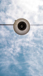 Low angle view of light bulb against sky