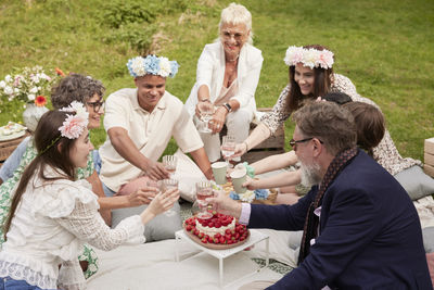 Family raising toast at picnic